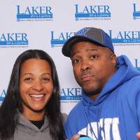 Husband and wife posing together with football